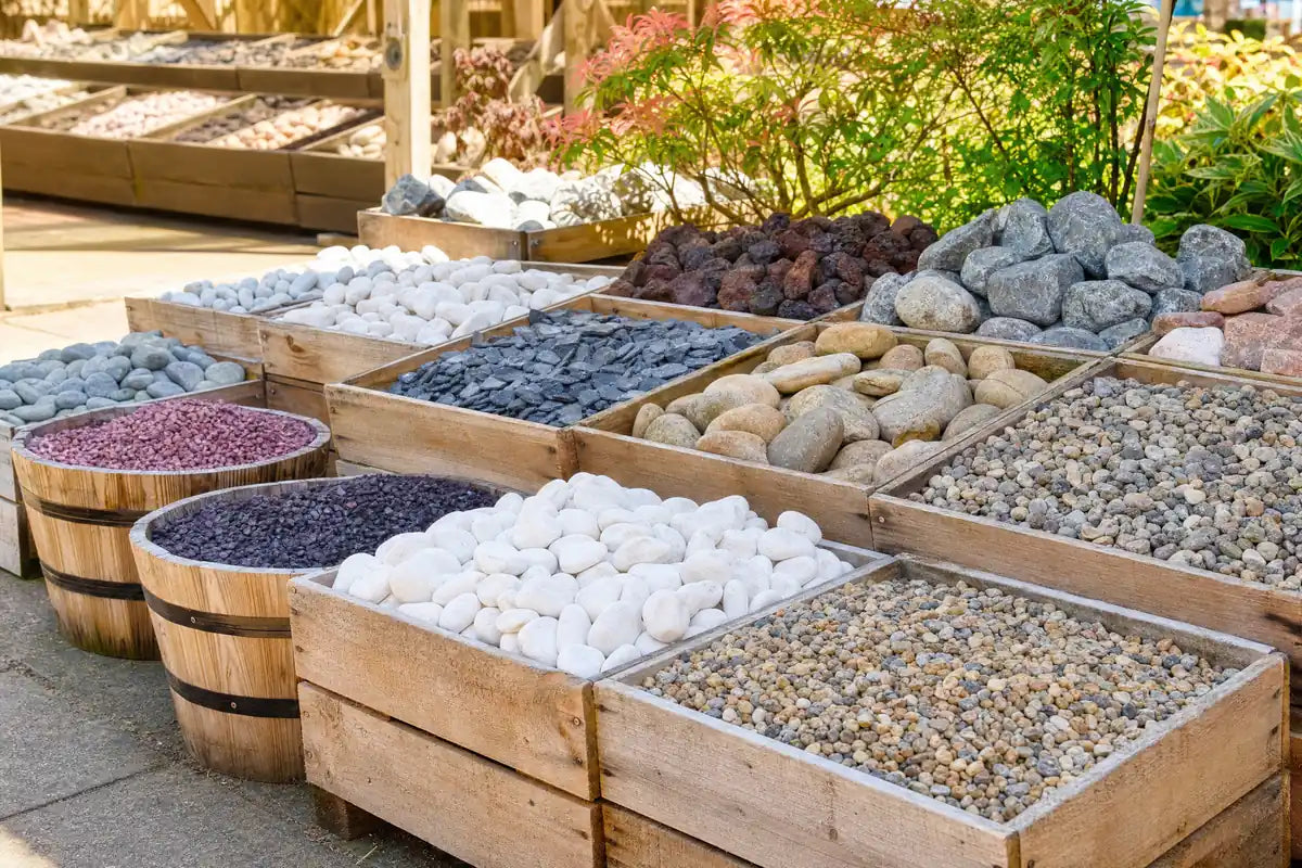 Decorative Stones & Chippings at Pengelly Cornwall with stacked bags of gravel, slate chippings and potted plants