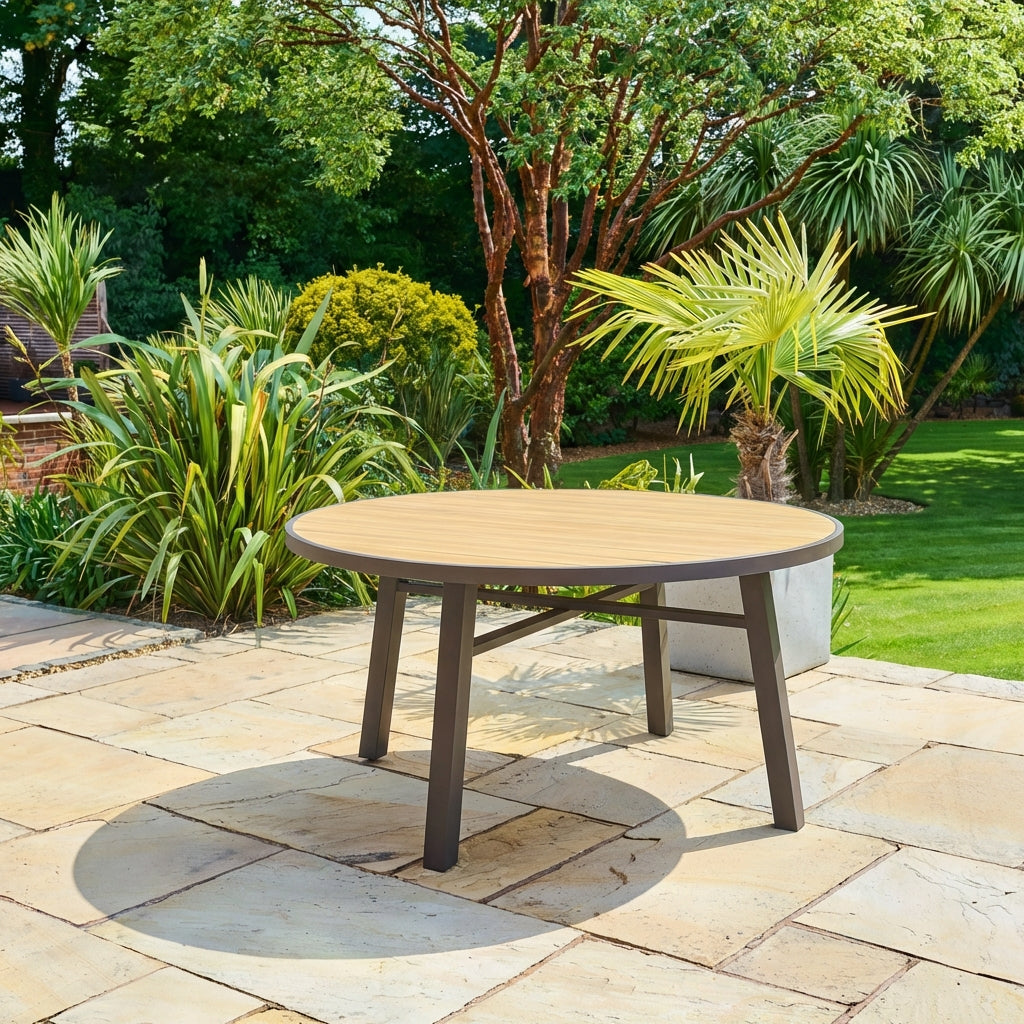 Bali round outdoor dining table in brown synthetic rattan with tempered glass top on patio, seats four