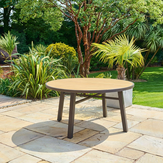 Bali round outdoor dining table in brown synthetic rattan with tempered glass top on patio, seats four