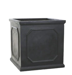 Square patio planter with mixed summer bedding plants — geraniums, petunias and trailing ivy on stone patio